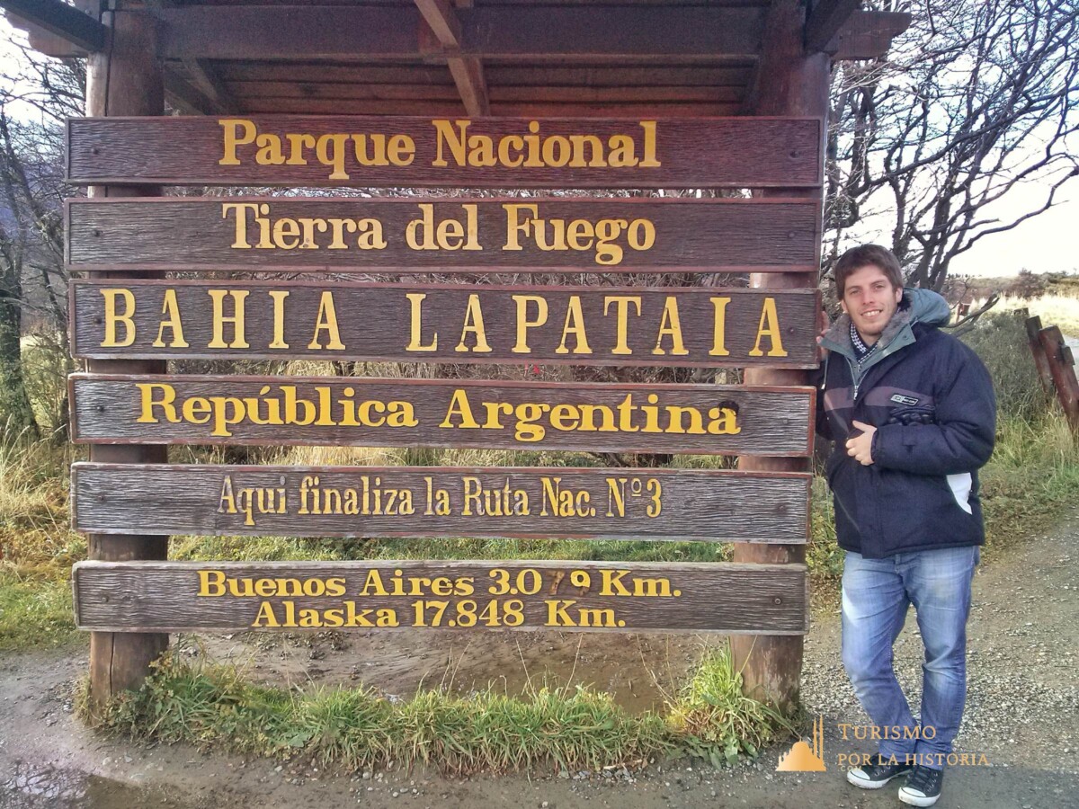 Cartel indicador del fin de la ruta nacional 3 con las distancias a Buenos Aires y Alaska y el nombre del parque y el lugar: Bahía Lapataia - Ushuaia